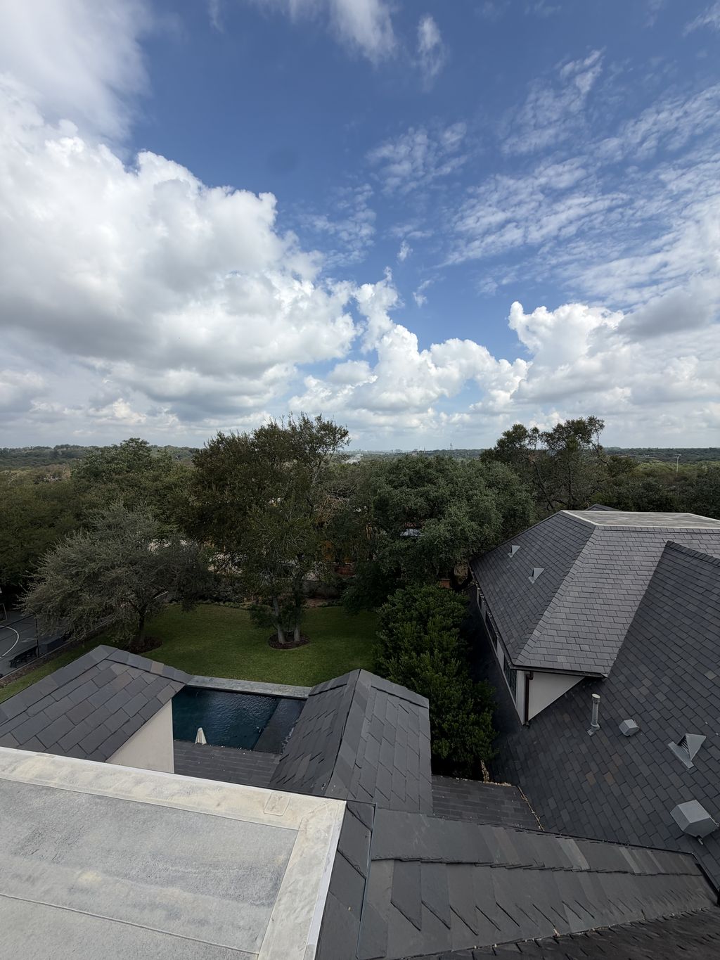 Aerial view across a finished slate roof with valleys and a low-slope section, San Antonio